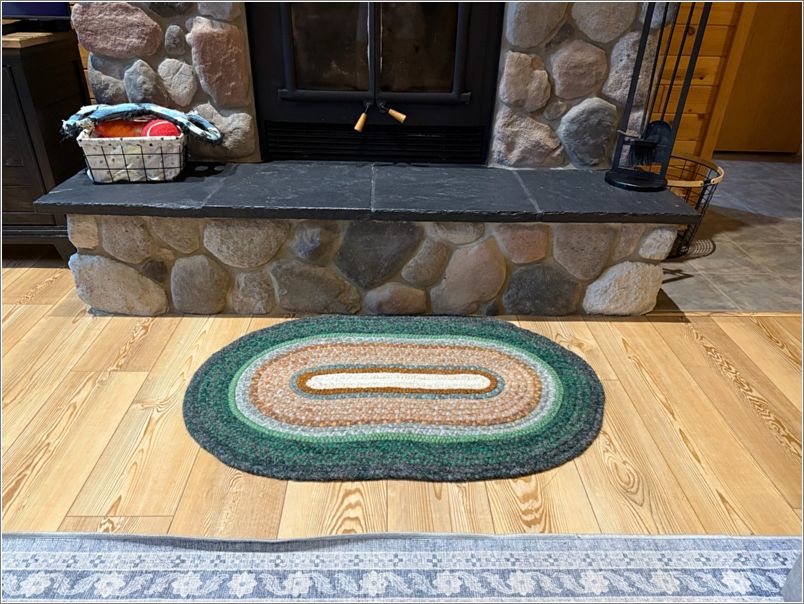 The braided rug I made for our neighbor in its new home in front of their fireplace. Photo: Letty Klein.